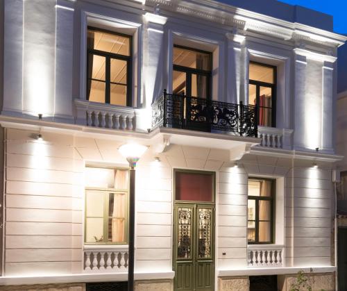 a white house with a green door and a street light at Chandax luxury villa in Heraklio Town