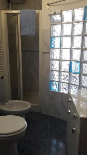 a bathroom with a toilet and a sink and a shower at Residenza Leonarda in Vado Ligure