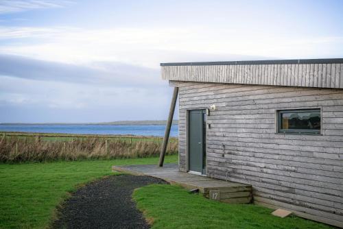 a small building with a door on the side of it at John O'Groats in John O Groats