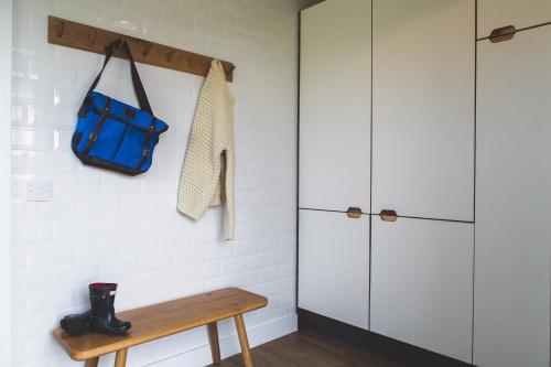 a room with a bench and a blue bag at John O'Groats in John O Groats