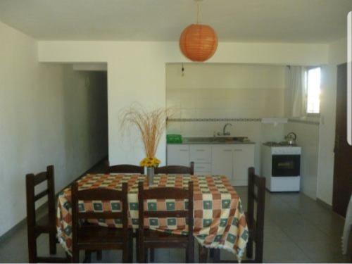 a dining room with a table and chairs in a kitchen at Maga in Piriápolis