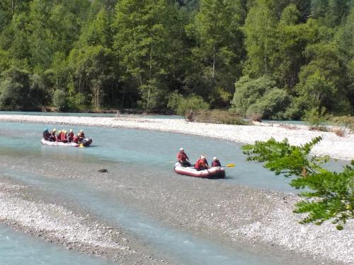 a group of people riding in canoes on a river at Le mas des Alberges in Le Bourg-dʼOisans