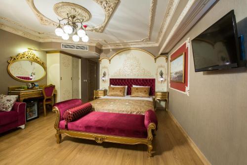 a bedroom with a large bed and a couch at Empire Suite Hotel in Istanbul