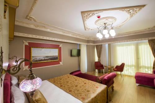 a hotel room with a bed and a living room at Empire Suite Hotel in Istanbul