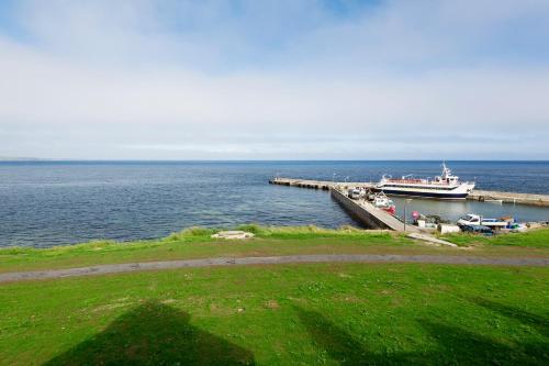 a boat is docked at a dock in the water at John O'Groats in John O Groats