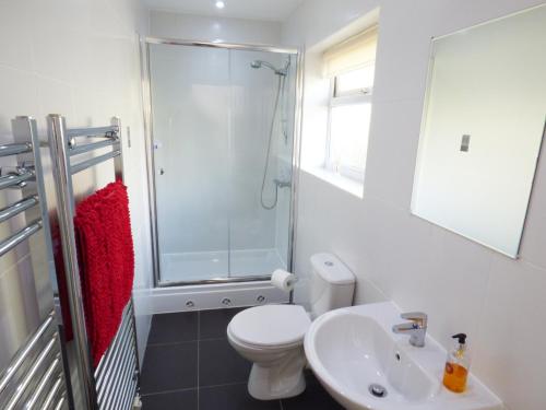 a bathroom with a toilet and a shower and a sink at The Bungalow in Burnley