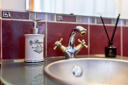 eine Flasche Seife neben einem Waschbecken in der Unterkunft Ada Old Town 7 in Braşov