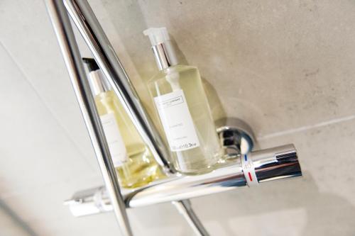 a bathroom sink with two bottles of soap at John O'Groats in John O Groats