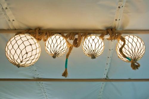 a group of light bulbs hanging from a ceiling at John O'Groats in John O Groats