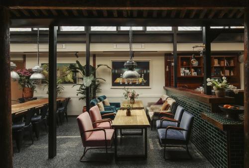 a restaurant with chairs and tables in a room at Peking Yard Boutique Hotel in Beijing