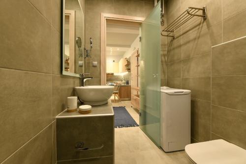 a bathroom with a sink and a toilet at Sunny Luxury Suite Stone in Kavála