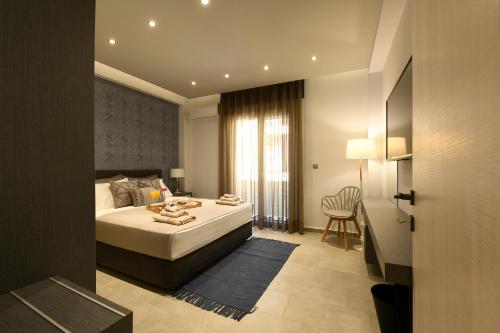 a bedroom with a bed and a table in it at Sunny Luxury Suite Stone in Kavála