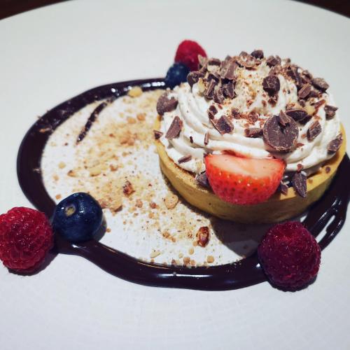 a dessert with whipped cream and berries on a plate at Mellon Country Inn Hotel in Omagh