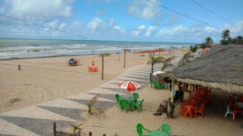 a beach with chairs and umbrellas on the beach at Hotel Portal Do Mar in Conde