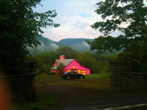 a car parked in front of a pink house at Play All Day - Sleep By The Stream at Night - Swimming Hole in Palenville