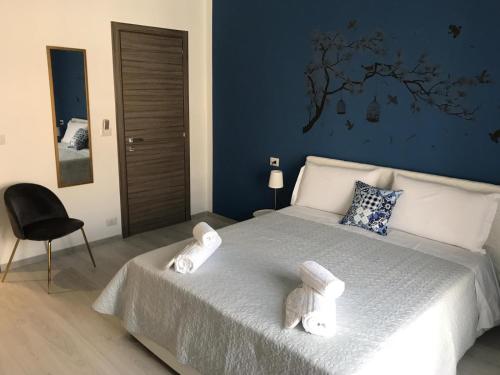 a bedroom with a bed with two towels on it at B&B Le Stanze Al Centro in Agrigento