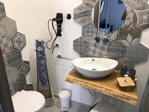 a bathroom with a sink and a toilet at B&B Le Stanze Al Centro in Agrigento