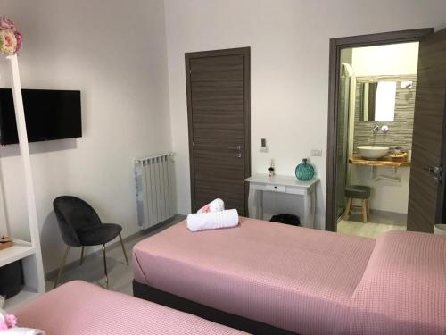 Postel nebo postele na pokoji v ubytování B&B Le Stanze Al Centro