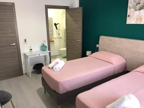 Postel nebo postele na pokoji v ubytování B&B Le Stanze Al Centro
