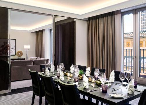 a dining room with a long table and chairs at Sofitel Frankfurt Opera in Frankfurt/Main