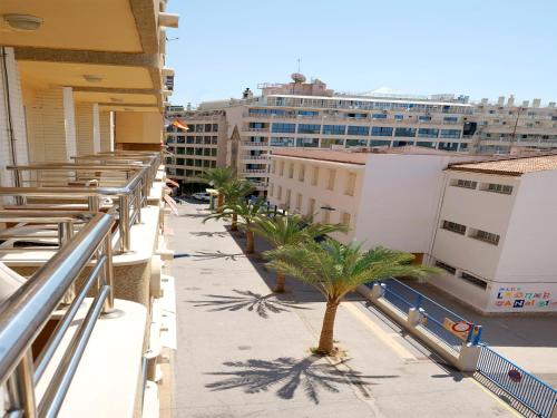 a view of a balcony with palm trees and buildings at Hostal Anna Benidorm in Benidorm