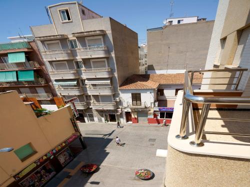 a child is walking on the balcony of a building at Hostal Anna Benidorm in Benidorm