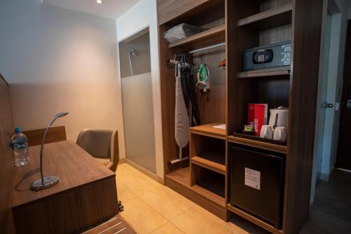 a room with a desk and a walk in closet at Casa Andina Select Zorritos Tumbes in Zorritos