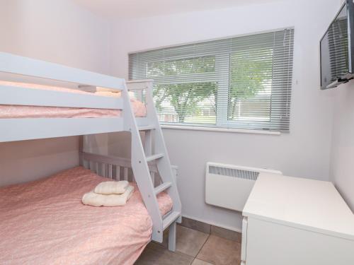 a bedroom with a bunk bed and a desk at 201 Norton Park in Dartmouth