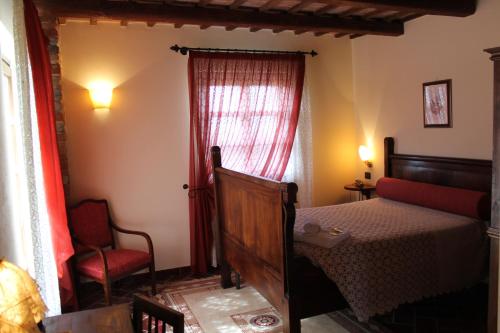 a bedroom with a bed and a red window at Il Palazzetto in Clavesana