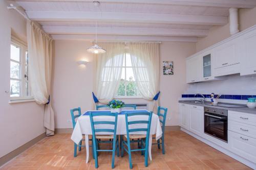 a kitchen with a table and chairs in a kitchen at Agriturismo Colle Oliveto in Orbetello