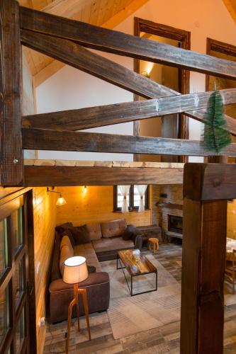 a living room with a couch and a loft at Brvnare Krstigora in Zaovine