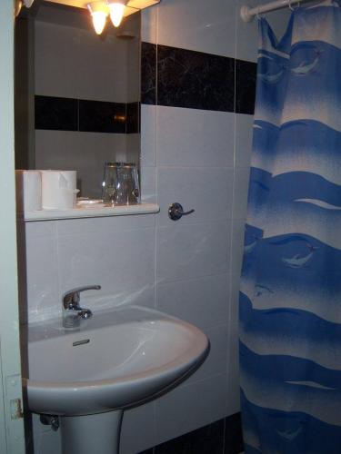 a bathroom with a sink and a mirror at Hotel Elena in Edessa