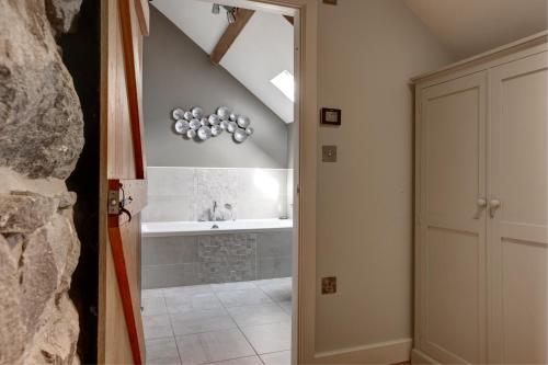 a bathroom with a sink and a bath tub at The Cottage Llyn Peninsula in Nefyn