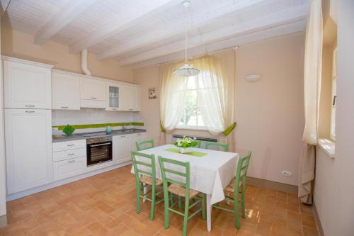 a kitchen with a table and chairs in a room at Agriturismo Colle Oliveto in Orbetello