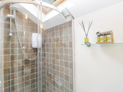 a bathroom with a shower with a glass door at Boundary Barn in Bristol