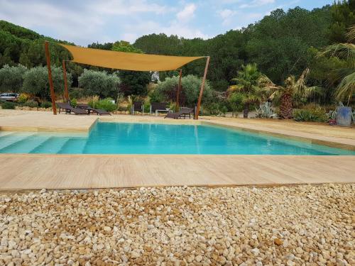 a swimming pool with a gazebo in a resort at Folco Studio Apartment in Piazza Armerina