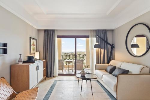 
a living room filled with furniture and a large window at Melia Villaitana in Benidorm
