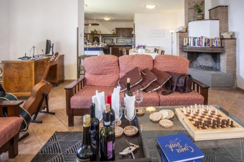 a living room with a couch and a table with wine bottles at Villa Monica B&B in Sorrento