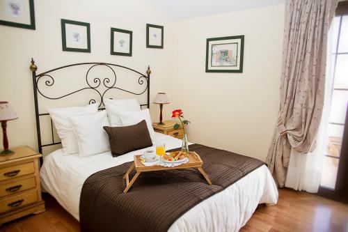 a bedroom with a bed with a tray of food on it at Fairways Club in San Miguel de Abona