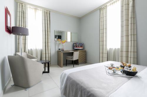 a hotel room with a bed with a tray of fruit on it at Palazzo Salgar in Naples