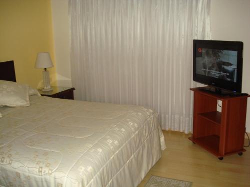 Ένα ή περισσότερα κρεβάτια σε δωμάτιο στο Apartamentos Santa Maria