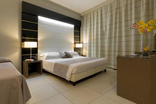 a bedroom with a bed and a vase of flowers at Palazzo Salgar in Naples