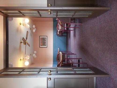 a mirror in a room with a chair in it at Best Seven Inn in Claresholm