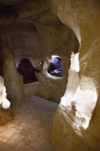 a cave with some rocks in a room with lights at Thermenhotel Quellenhof in Bad Füssing