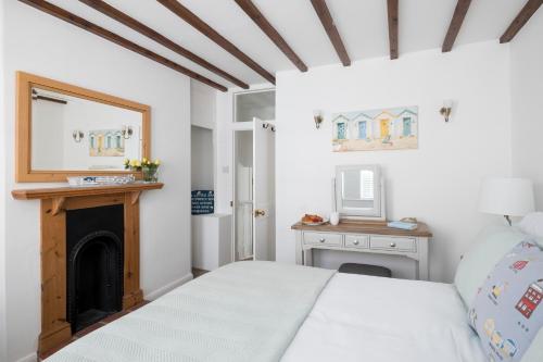 a bedroom with a bed and a fireplace at Fossil Cottage in Whitby