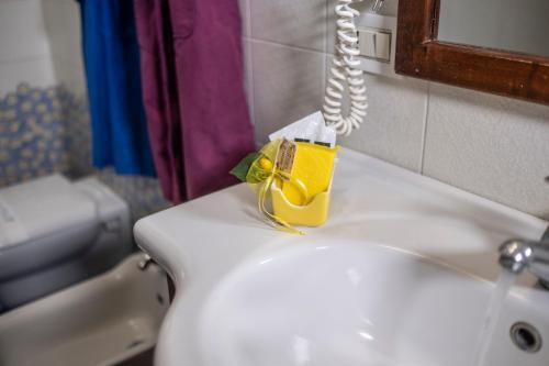 a soap dispenser on a white sink in a bathroom at Villa Monica B&B in Sorrento