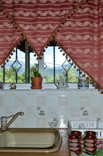 a kitchen counter with a sink and a window at Doloi garden house in Málta