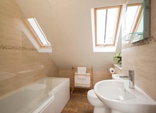 a bathroom with a sink and a toilet and a tub at Limber View in Grosmont