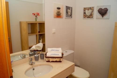 a bathroom with a sink and a toilet at Porto Santo Blue House in Porto Santo