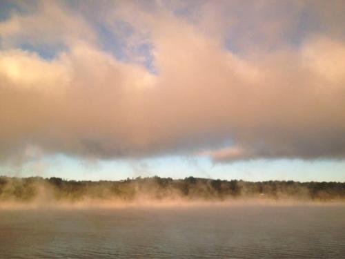 a misty lake under a cloudy sky with trees at Play All Day - Sleep By The Stream at Night - Swimming Hole in Palenville